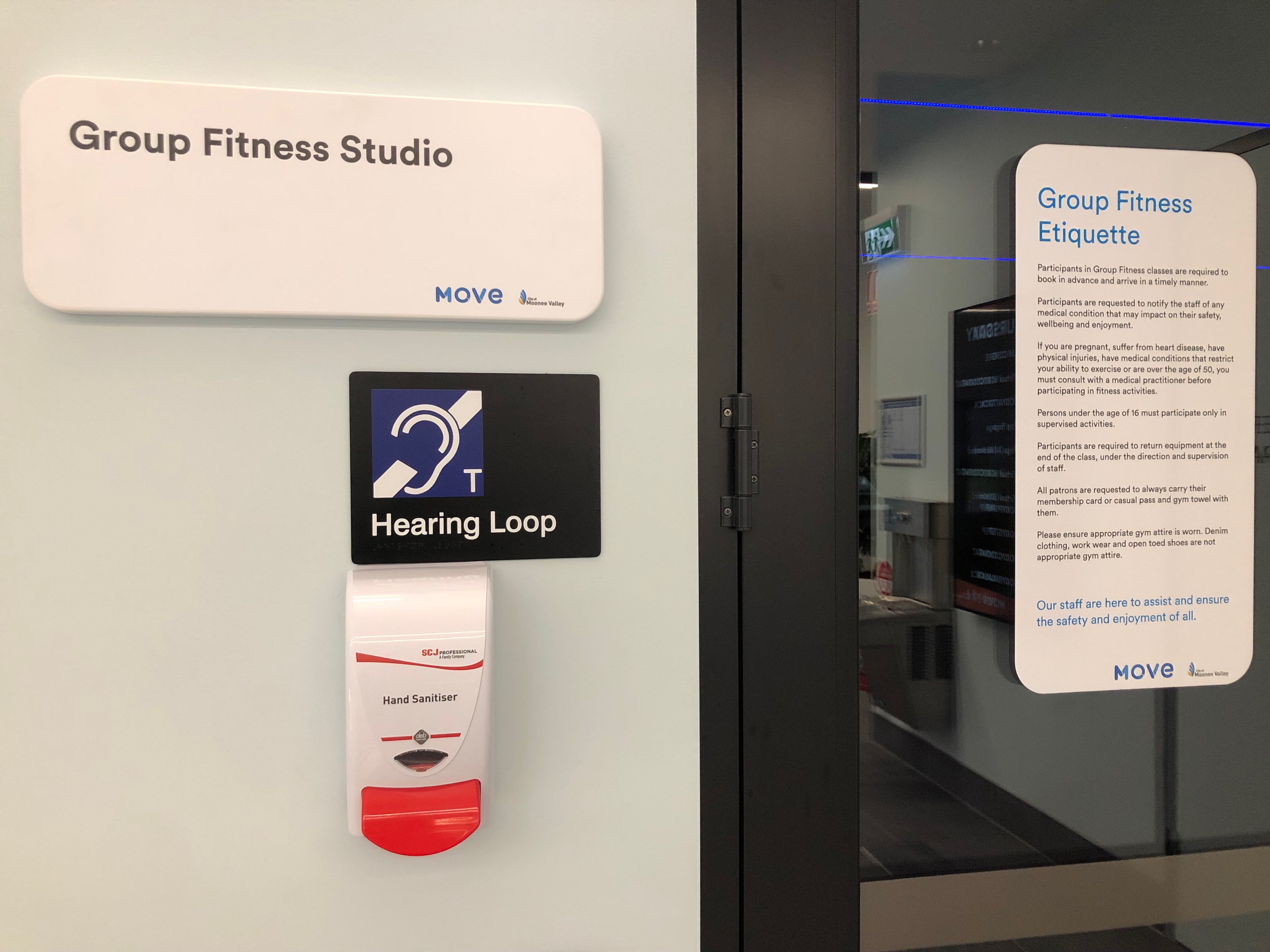 Image of group fitness studio entrance door with Hearing Loop signage